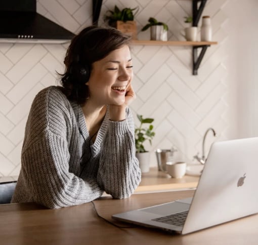 person smiling, looking at a videocall